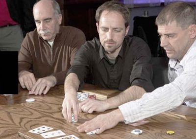 Poker players on wood top casino table